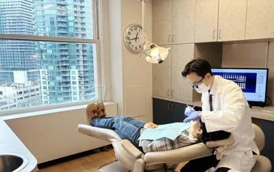 Dr. Harry Shin providing dental care to a patient at Moritis & Shin Dentistry